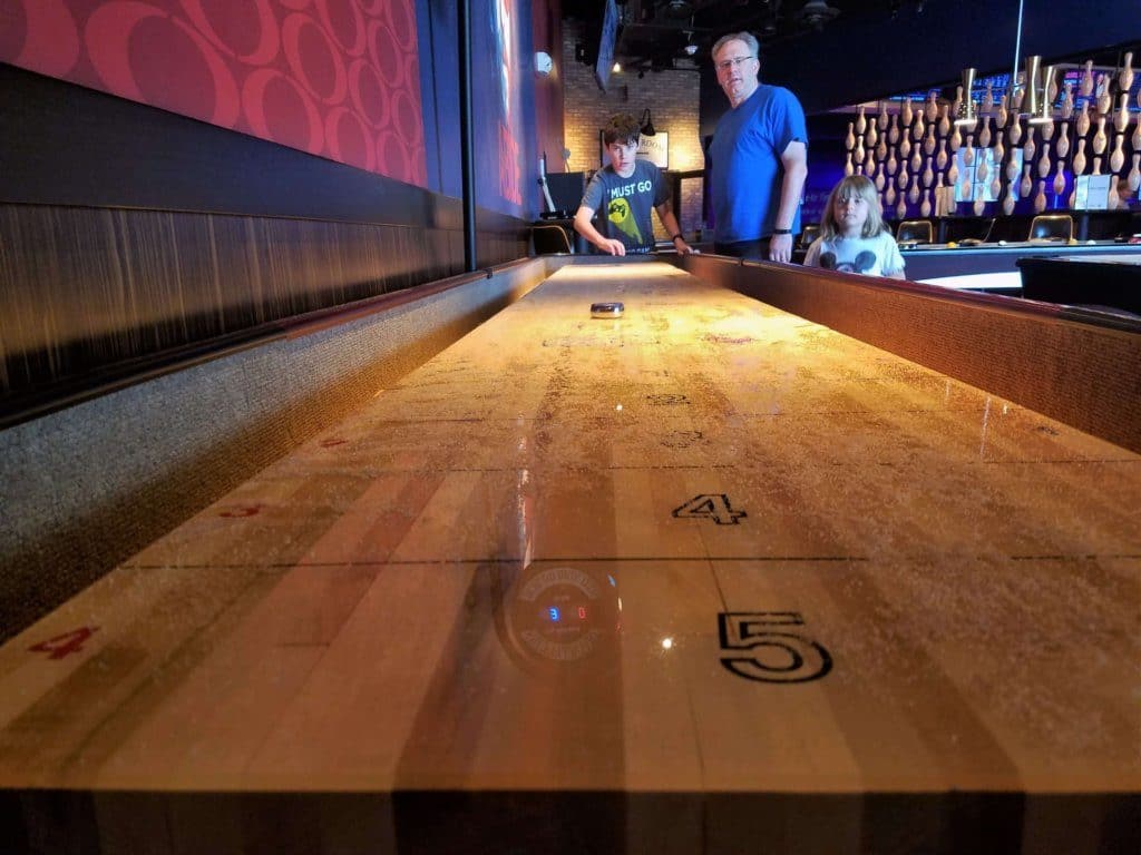 kings bowl shuffleboard from the end of the table