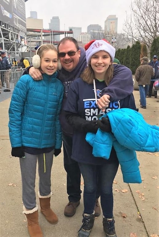 Jim and his daughters at a Titans game