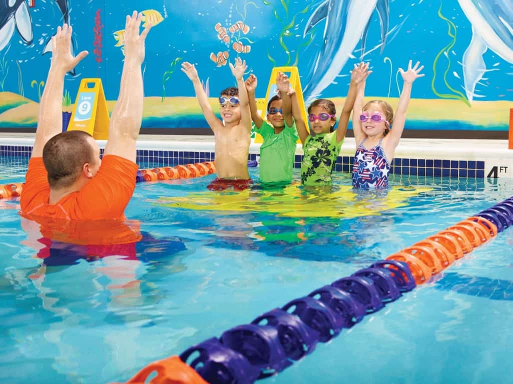 Goldfish Swim School - an instructor with four kids in the pool