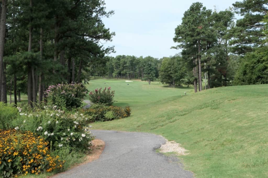 A paved path for a golf cart winding through the green on the golf course at Kentucky Dam Village State Park.