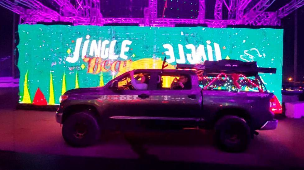 Jingle Beat Holiday Lights Drive Thru - Truck in front of the Jingle Beat sign