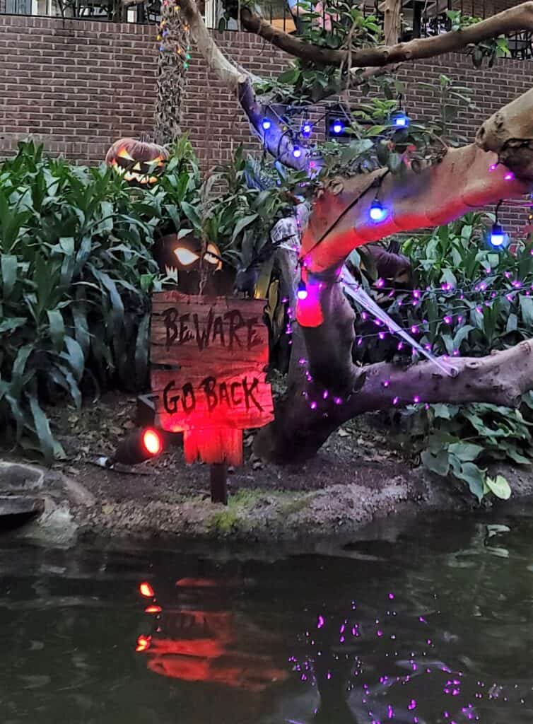 Beware, Go Back sign in the Delta atrium on the Ghouls Night Out boat ride.
